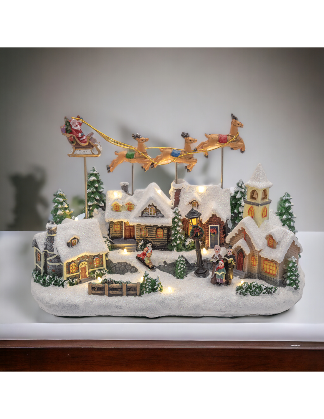 Villaggio di Natale Innevato con Chiesa 34x23cm, Babbo Natale su Slitta Volante, Renne in Movimento
