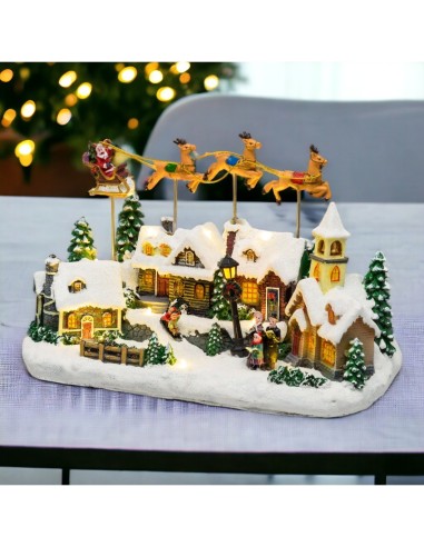 Villaggio di Natale Innevato con Chiesa 34x23cm, Babbo Natale su Slitta Volante, Renne in Movimento